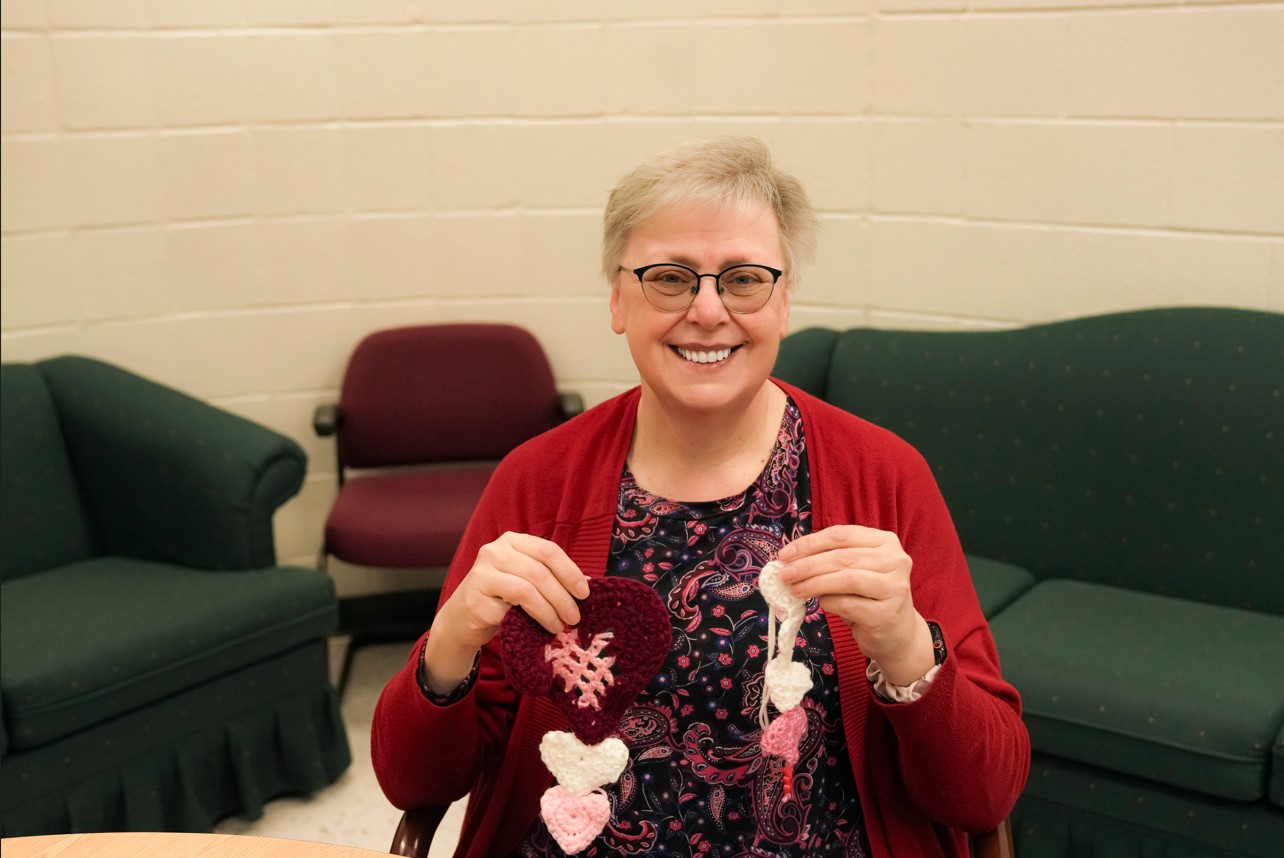 Mrs. Pam shows off some of the hearts used for the Valentines Yarn Bombing of 2022. 