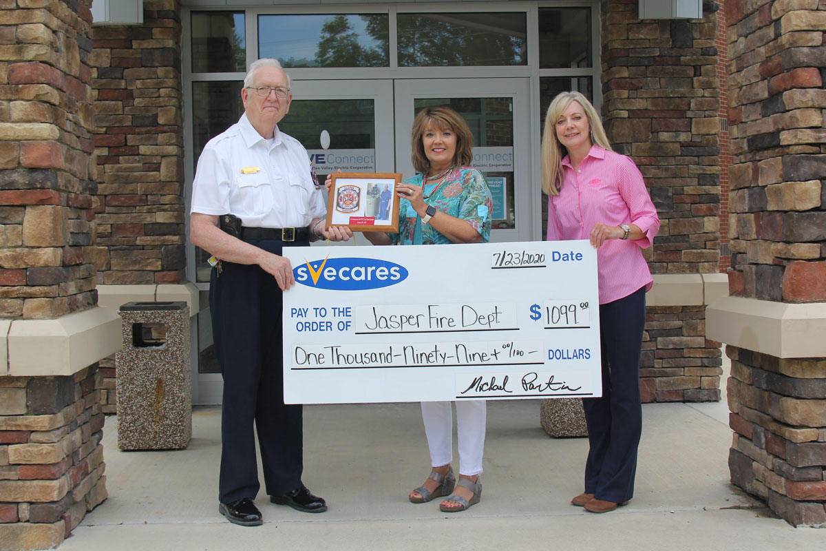 Photo, above: SVEC's Joan Davis (center) and Christy Lawrence (right) receive a plaque from the Jasper Fire Department, in appreciation of a recent SVECares donation to the group.